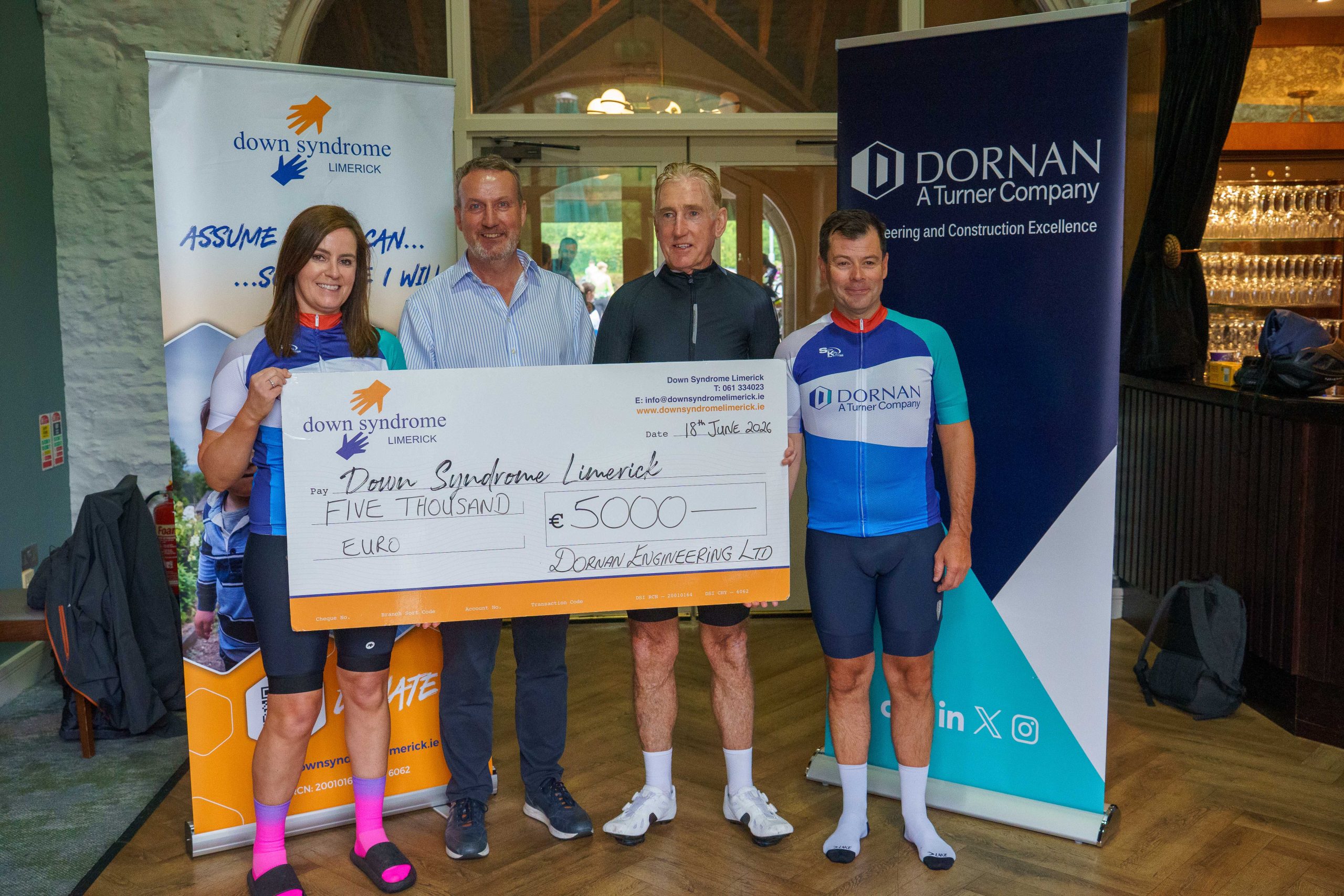 Micheál O Connor, Group Managing Director at Dornan standing for a photo with Julette from Down Syndrome Limerick